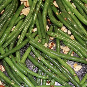 Close up of Autumn Green Beans in a black cast iron pan with sliced almonds