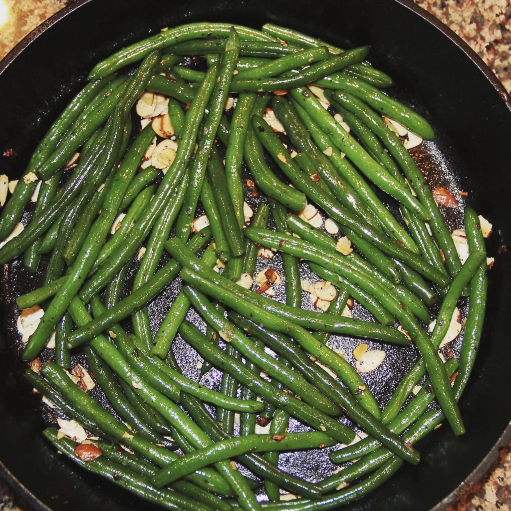 Squre photo of Autumn Green Beans in a black cast iron pan