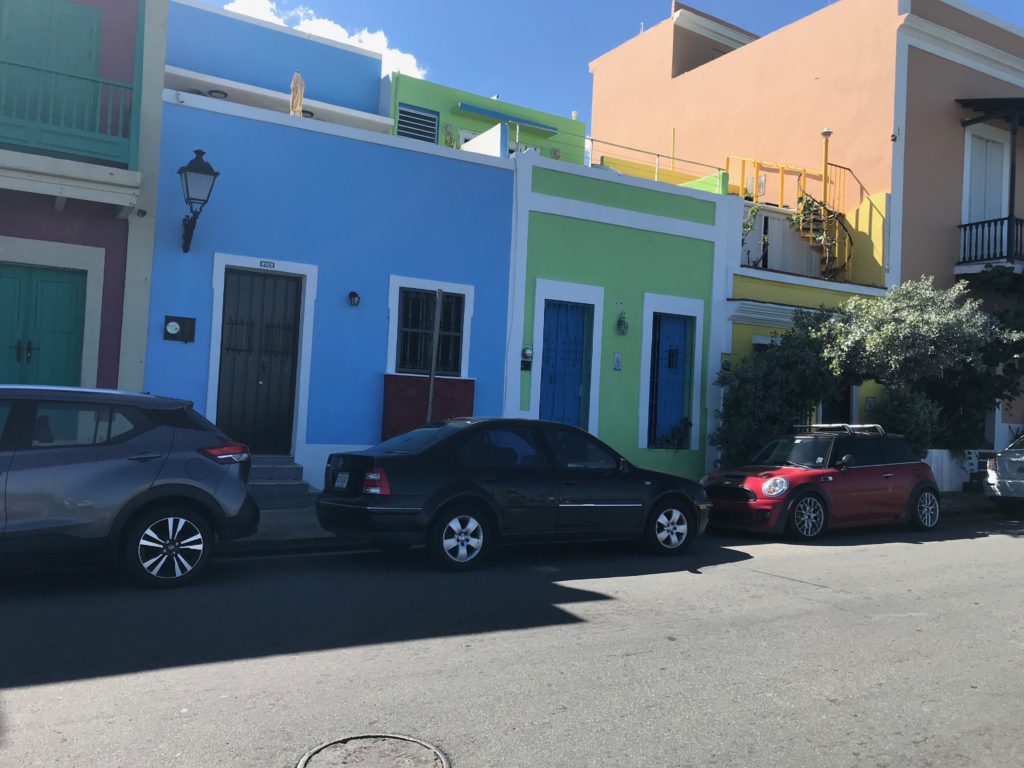 STreet in San Juan, Puerto Rico, with bright blue and green buildings. A day in port. 