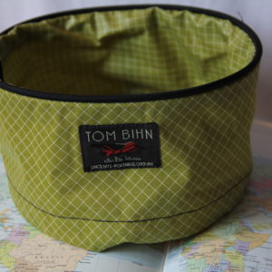 Large green Tom Bihn travel tray. Has a drawstring and is perfect for holding travel necessities.