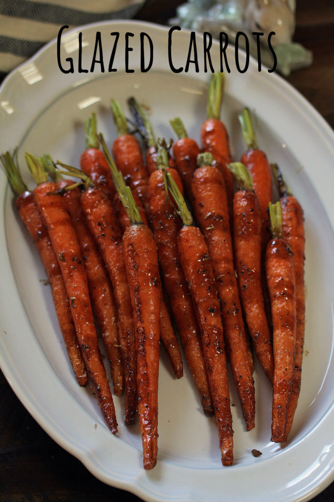 18 honey glazed carrots on a white oval ceramic serving dish, labeled Glazed Carrots.