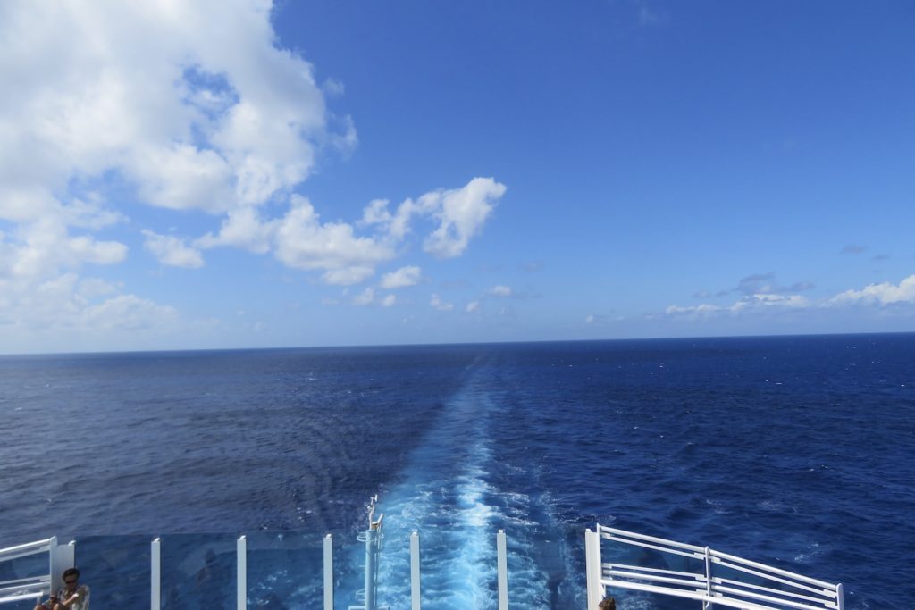 Photo from aft of the Sky Princess cruise ship showing wake and bright blue shies. How to stay healthy on a cruise