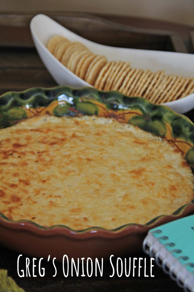 Greg's Onion Soufflé, made with onions, cream cheese and parmessan cheese, hot from theoven, in a round, green pie plate