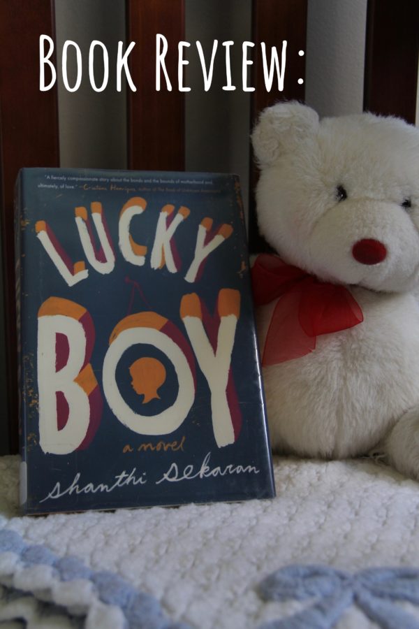 The book Lucky Boy, on a handmade baby blanket, with a white teddy bear next to it. Book review.