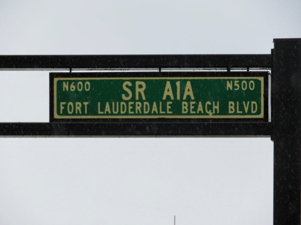 Green road sign with gold lettering, SR A1A, Fort Lauderdale Beach Blvd.
