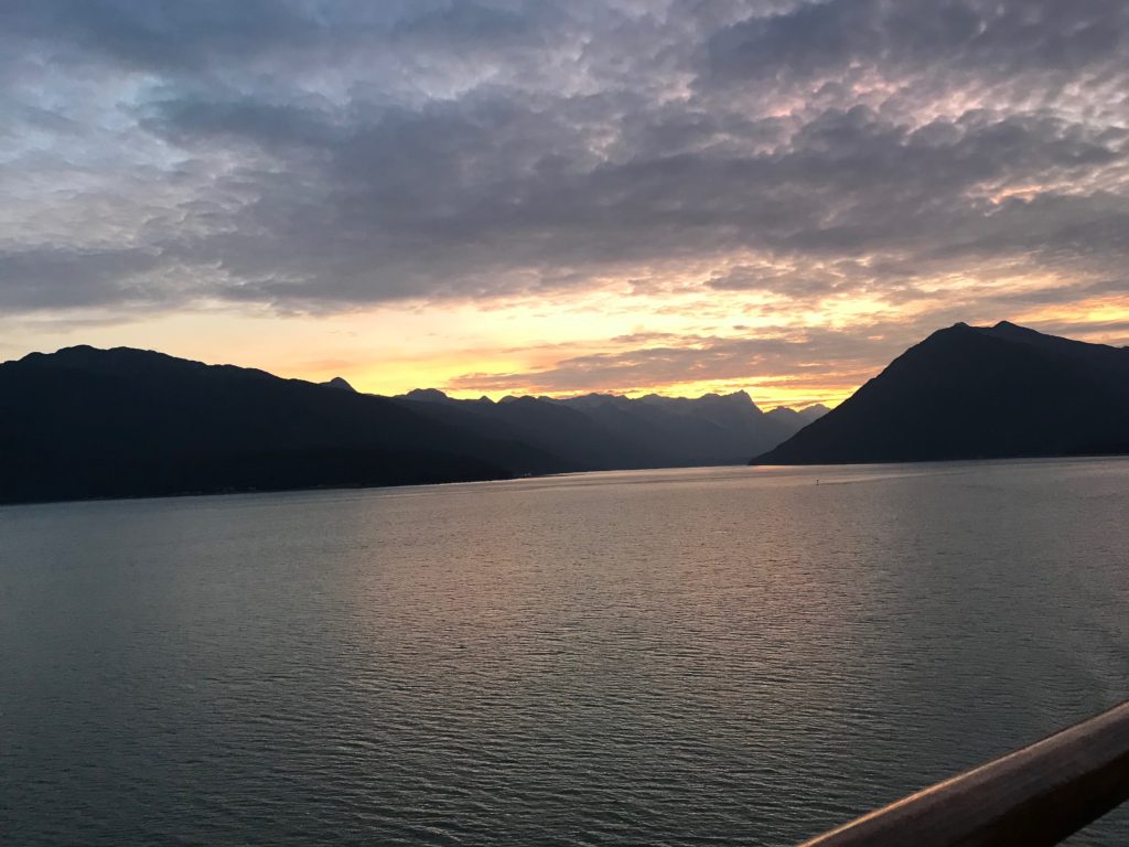 Beautiful sunset while on an Alaska cruise with pinks and yellow in the horizon