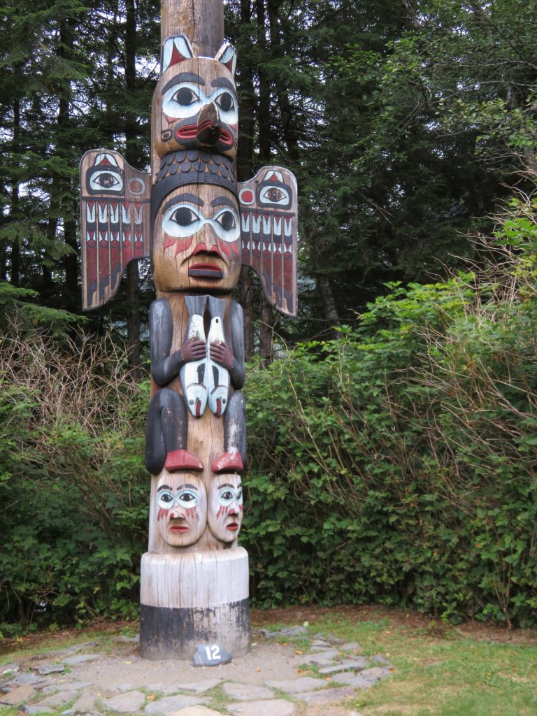 Hand carved totem ole, with wings and other carvings as displayed at Bight State Park in Ketchikan. Just one thing to do when in the Port of Ketchikan