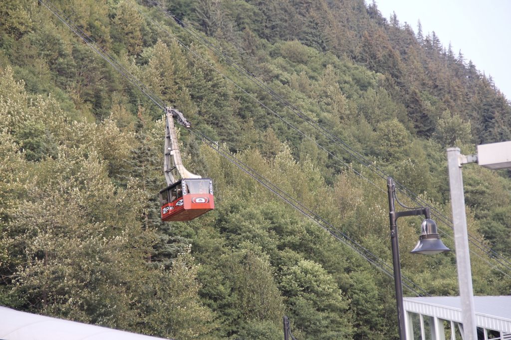 Red Mount Roberts Tram going down mountain in Juneau on a summer day