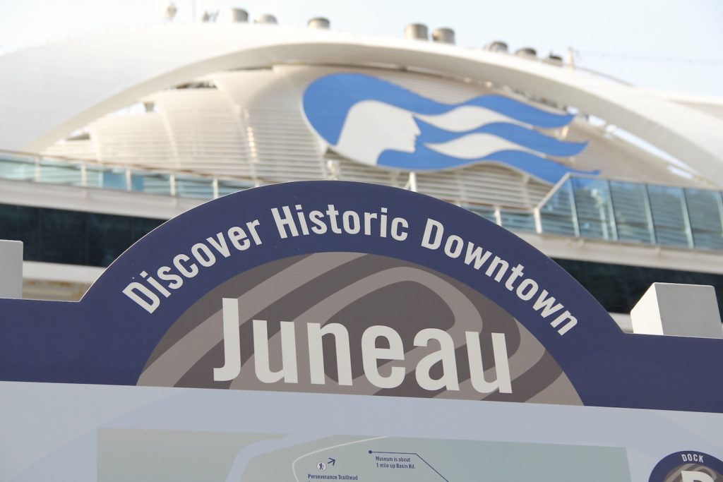 Sign as you enter Juneau via cruise ship saying "Discover Historic Downtown Juneau" above as you walk to town