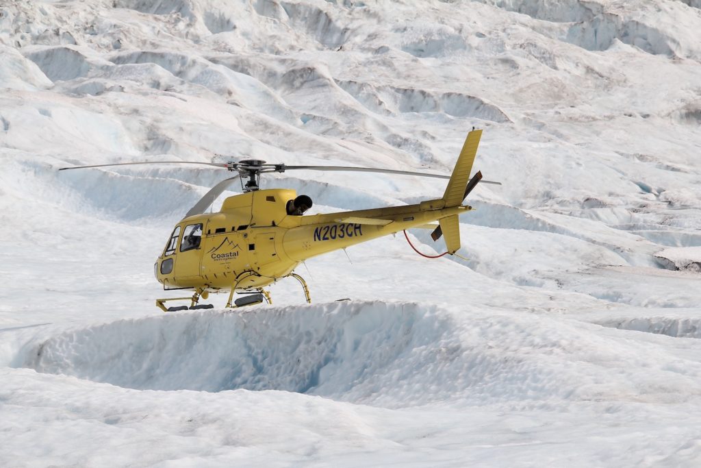 Yellow helicopter, landed on an Alaska glacier. Alaska cruise tips