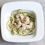 Tequila Lime Shrimp over zucchini noodles in a square white ceramic shallow bowl